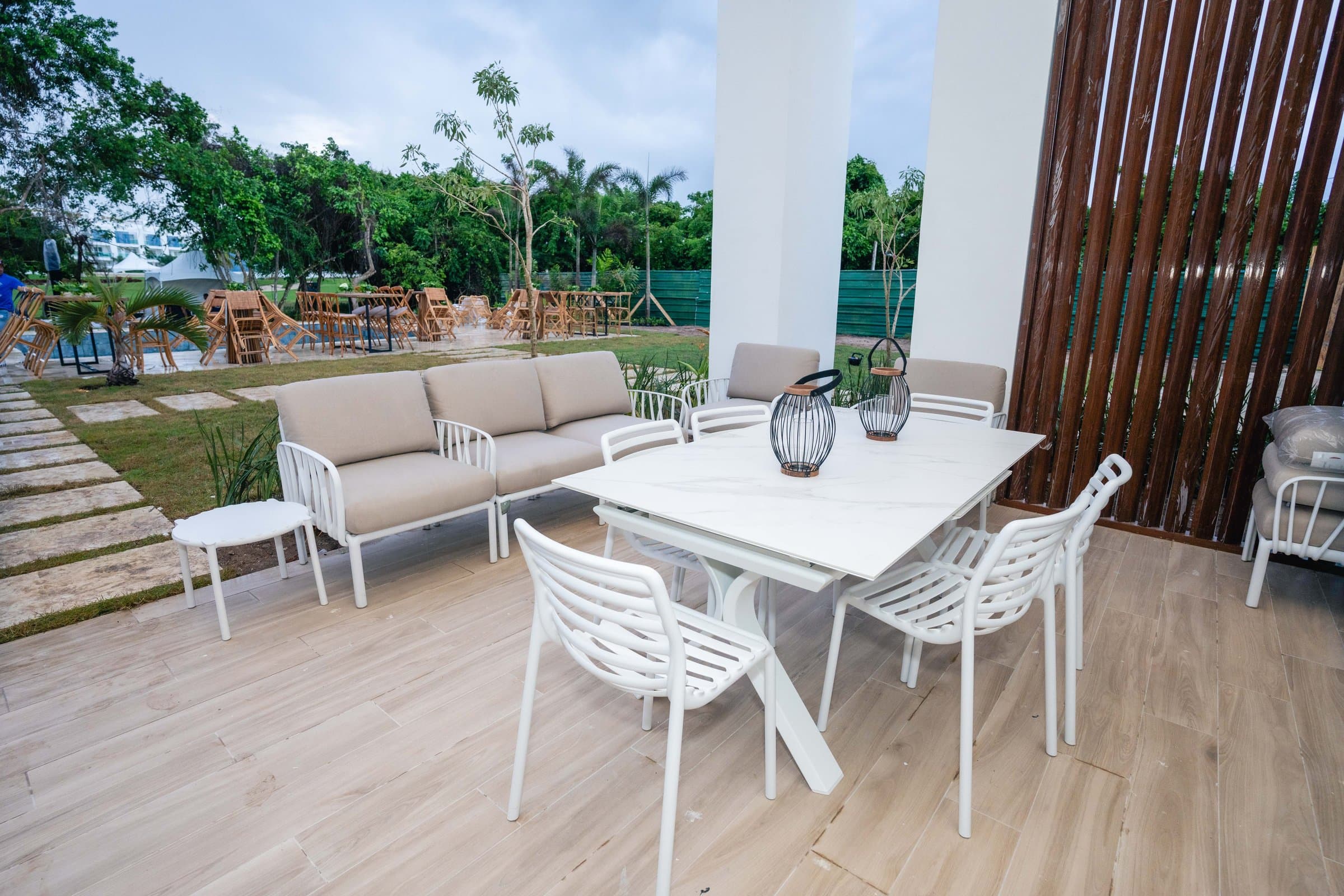 Covered terrace with lounge seating at a Baycana residence
