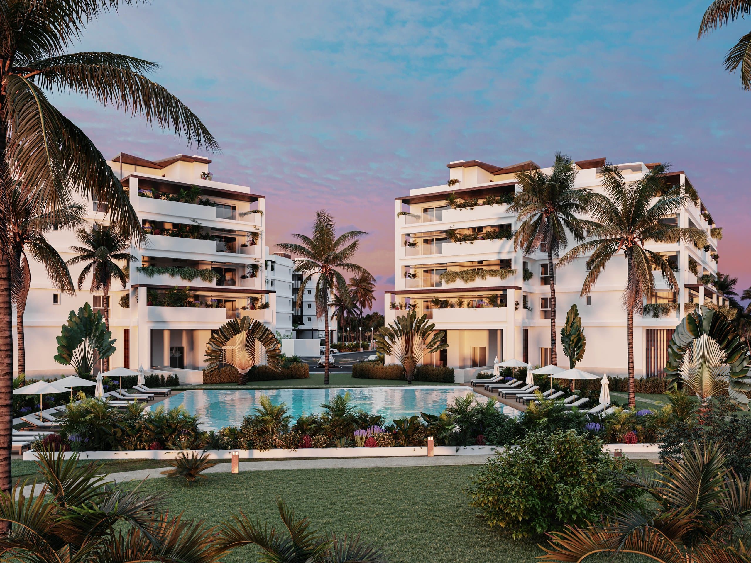 Baycana residential buildings at Cana Bay at twilight, with a landscaped pool and palms — artist rendering of the development.