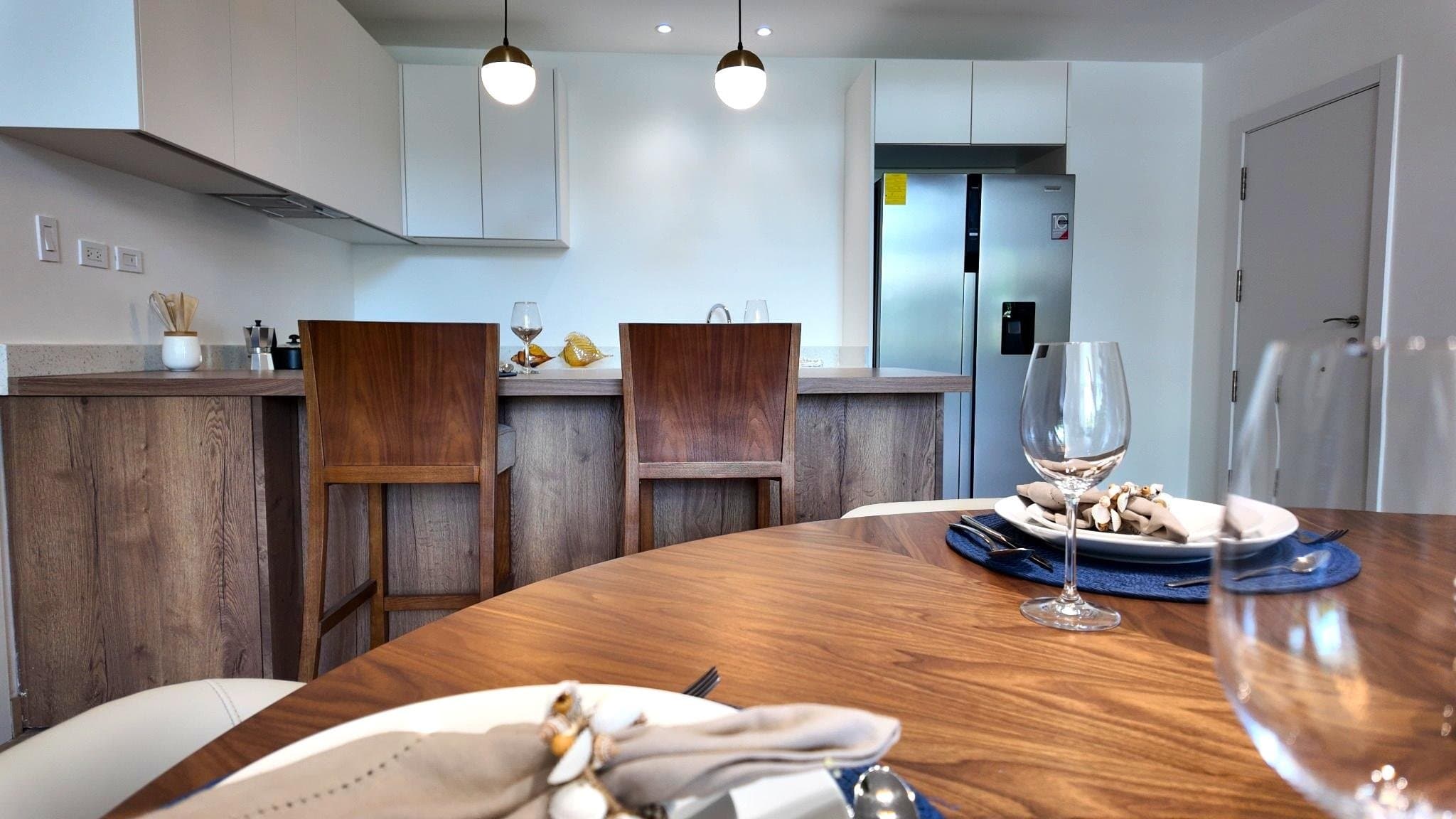 Open kitchen with timber island and integrated appliances