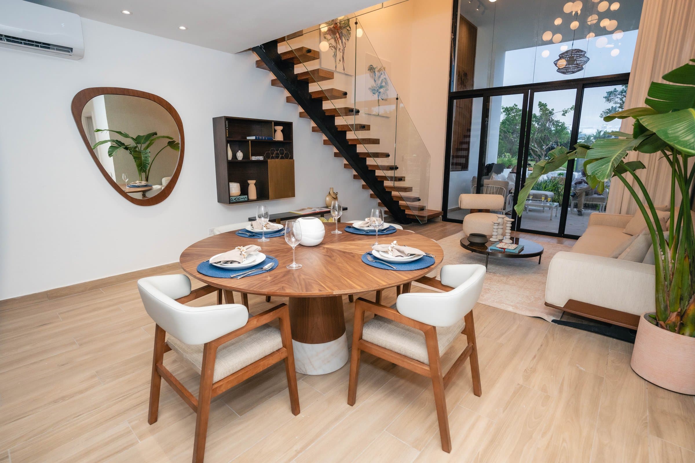 Double-height living and dining area with sculptural staircase